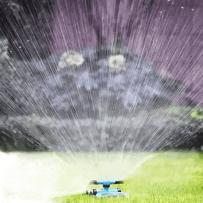 Blue Rotating Garden Sprinklers Watering Grass