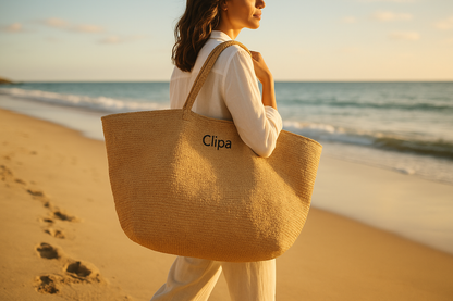 Lifestyle image of woman carrying Clipa XXL Raffia Beach Tote Bag on beach